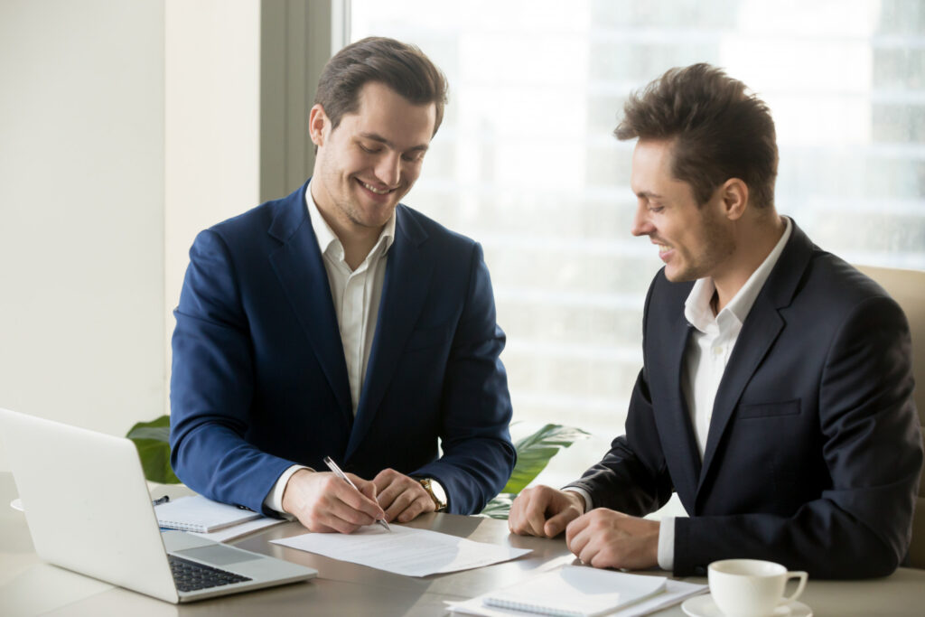 handsome-businessman-signing-contract-with-partner-As a manager or team lead, identifying opportunities for improvement, streamlining efficiency, and articulating constructive feedback are everyday tasks. On the opposite side of the coin, it is also your responsibility to recognize hard work, celebrate employee wins, and lead a motivated and engaged team. - RumboMag